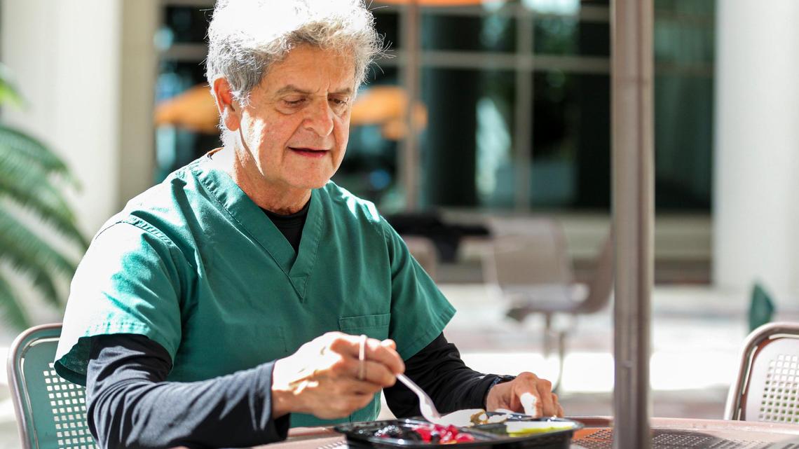 Dr. Eduardo de Marchena, associate dean for International Medicine Institute and professor of medicine and surgery and interventional cardiologist at University of Miami Health System, enjoys a healthy lunch outside his office at the University of Miami Schoninger Research Quadrangle, Friday, Feb. 12, 2021. He had developed hypertension and lost nearly 40 pounds, enabling him to get off his blood pressure medication.